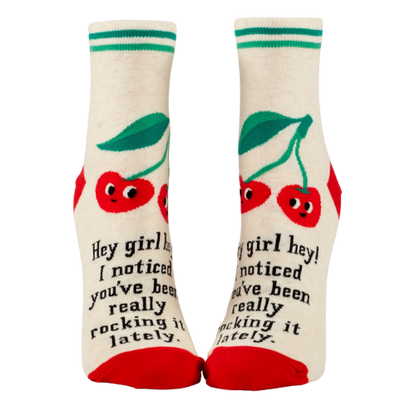 Blue Q ankle socks featuring the message "Hey Girl Hey! I Noticed You’ve Been Really Rocking It Lately," designed to spread positivity and celebrate hard work.