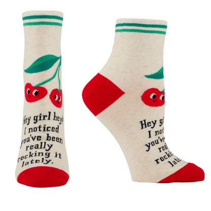 Blue Q ankle socks featuring the message "Hey Girl Hey! I Noticed You’ve Been Really Rocking It Lately," designed to spread positivity and celebrate hard work.